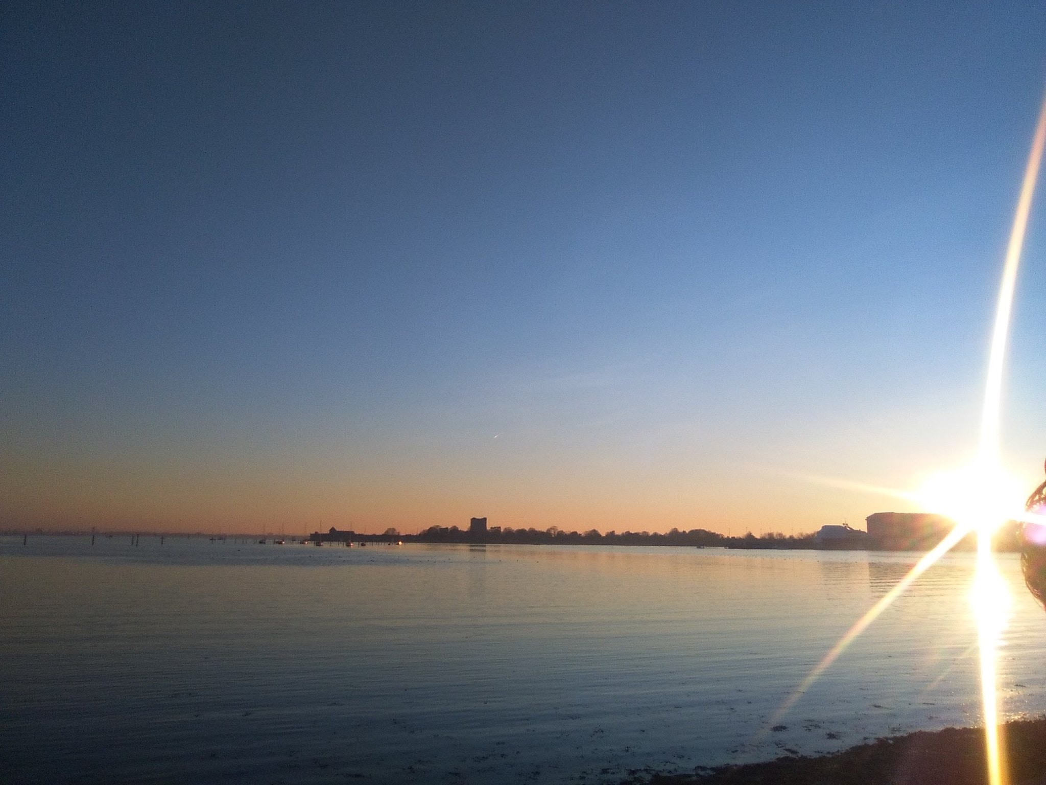 Sunset flare over Portsmouth waterfront