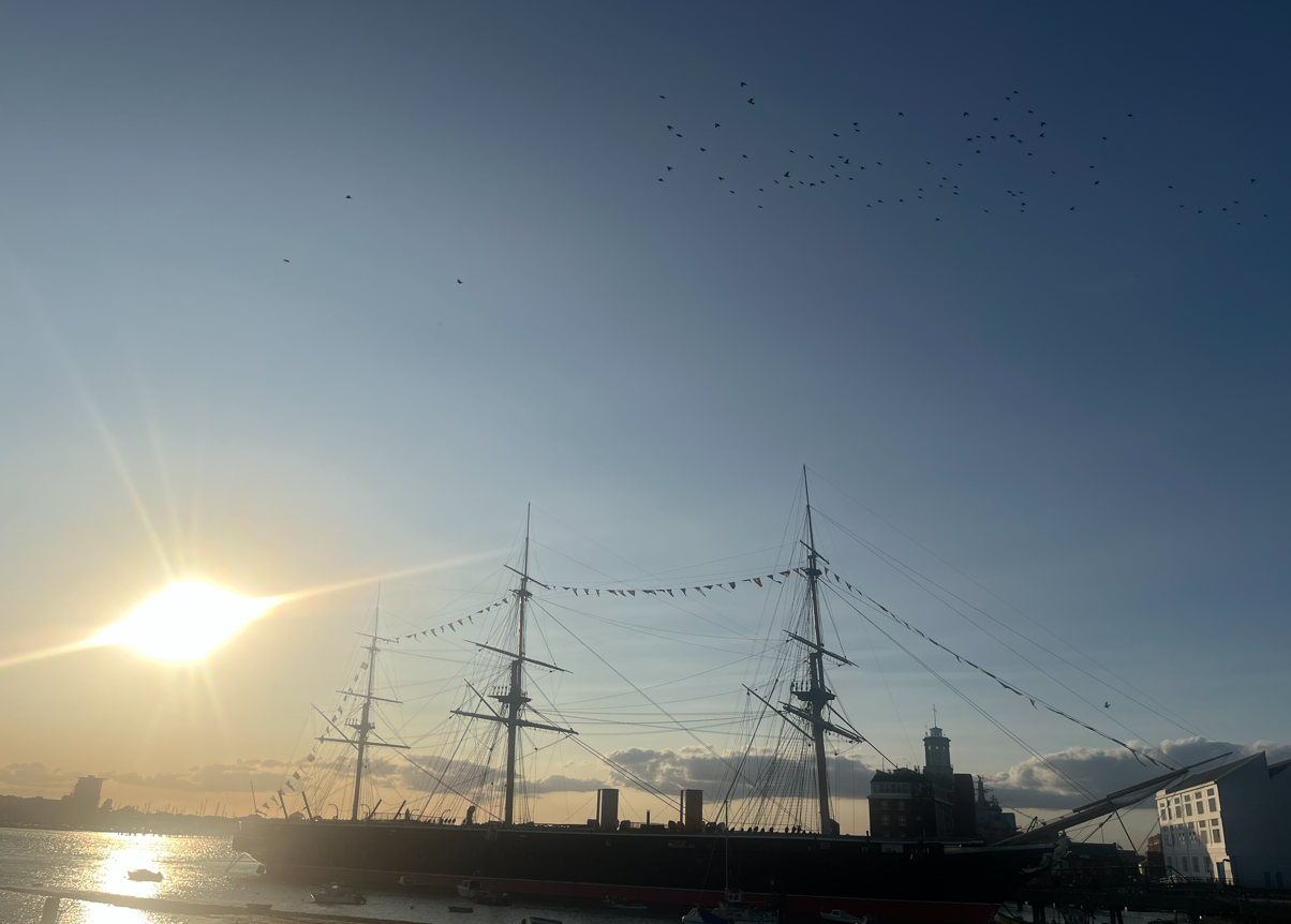 HMS Victory historic sailing ship at sunrise in Portsmouth Harbour